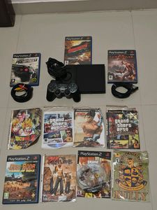 PS2 Console With 11 CD's (Non Working)