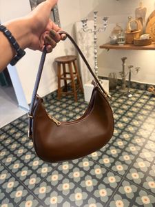 brown sling bag with belt