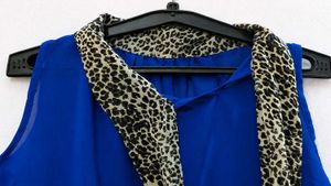 Stylish Blue Sleeveless Top with Scarf Detail