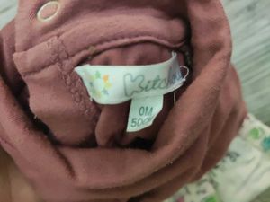 Bundle of baby clothes, beanie, shoes.
