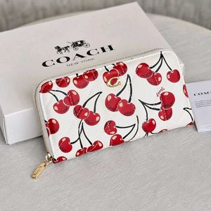 Coach Accordion Zip wallet featuring pillow quilti
