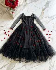 Elegant Black Gown with Red Floral Accents