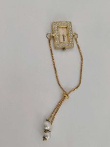 Elegant Gold Watch with Pearl Detail