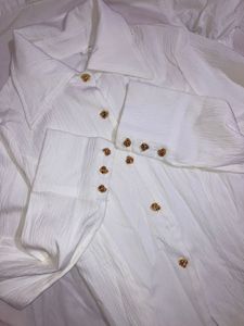 white shirt with gold button details