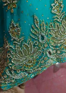 Exquisite Teal Saree with Intricate Gold Embellish