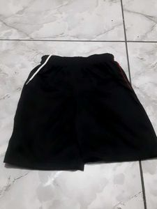 Black athletic shorts with red trim