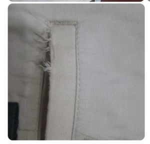 Off-white formal trousers for men.
