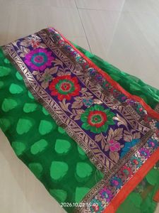 a printed saree with net in green color which look