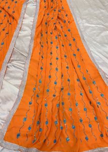 Vibrant Orange Saree with Blue Embellishments