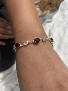 Elegant Gold Bracelet with Red and Clear Stones