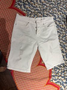 A pair of sexy white distressed shorts