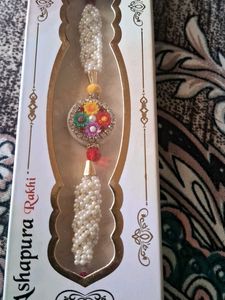 Beautiful Pearl Rakhi with Floral Pendant