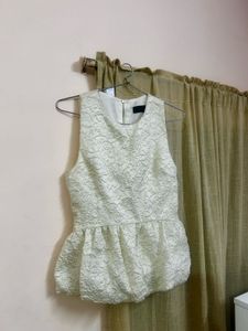 The ivory peplum top
