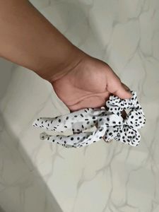 A pair of white and fur scrunchies