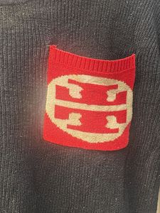 Black Sweater with Red Pocket Detail