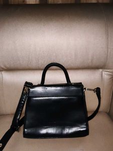 Chic Black Handbag with Gold Accent