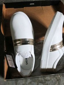 Stylish White Slip-On Sneakers with Gold Accent