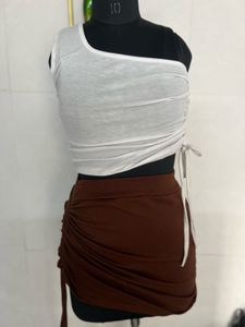 white top and brown skirt
