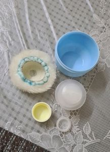 Baby powder puff with a refill container