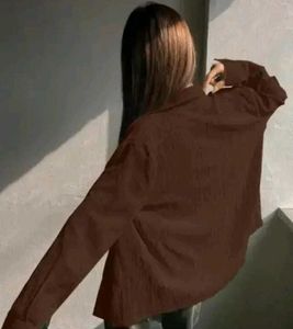 brown shirt with black buttons