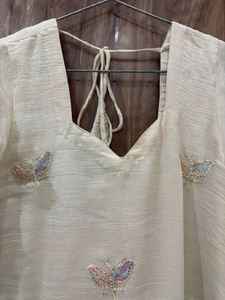 an elegant, cream-toned traditional Indian Kurta