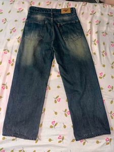 Faded indigo blue denim jeans