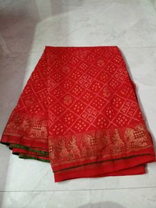 Vibrant Red Bandhani Saree with Elephant Border