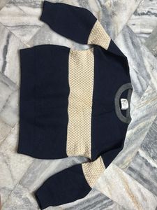 a knit sweater in shades of navy blue and beige