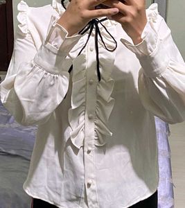 Ruffled White Blouse with Black Bow