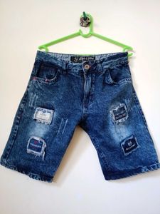 Casual distressed blue denim shorts.