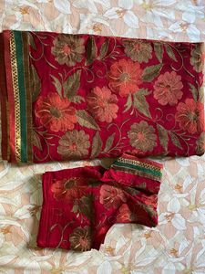Maroon coloured Embroidered saree With Stitched blouse