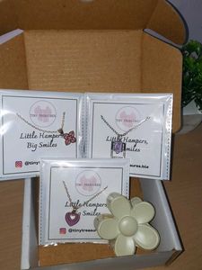3 charm necklaces and one pastel flower claw