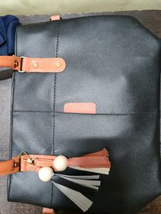 Chic Black Tote Bag with Tassel Accent
