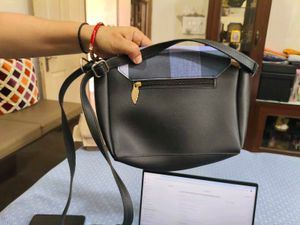 Chic Black Crossbody Bag with Striped Accent