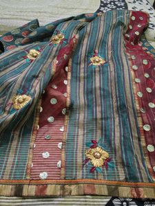 Elegant Teal Saree with Floral Motifs