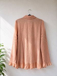 Chic Peach Textured Blouse with Ruffle Hem