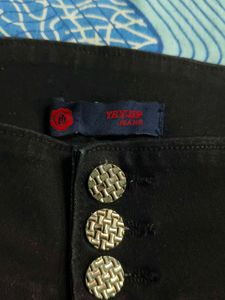 Stylish Black Jeans with Unique Buttons