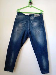 men's heavily distressed / ripped blue denim jeans