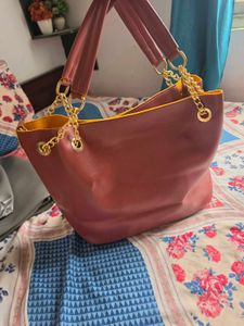 Chic Maroon Handbag with Gold Chain Accents