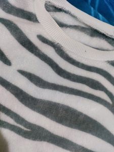 White Velvet Sweater With Black Stripes On It