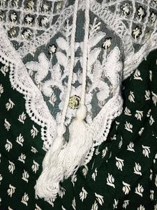 A beautiful dark green short kurti with embellish