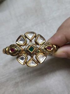 Elegant Gold Bangle with Green Stones
