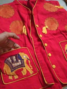 long yellow gown with red embroidered jacket