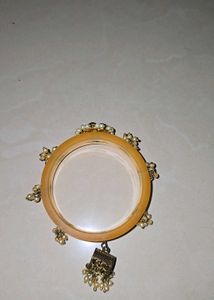 Elegant Yellow Bangle with Pearl Tassels