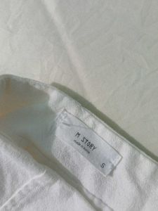 Chic White Mini Skirt with Grommet Detail
