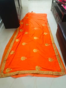 beautiful golden embroidery border orange saree
