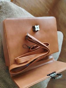 Stylish Tan Handbag with Flower Clasp