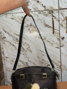 Chic Black Handbag with Pom-Pom Charm