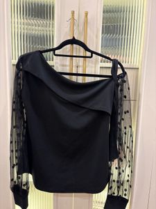 Chic Black Top with Polka Dot Sleeves
