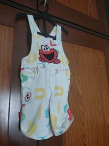 white dungaree with orange tshirt